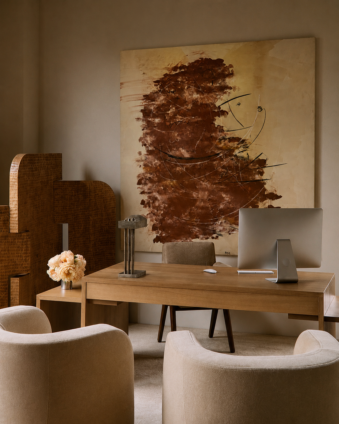 Modern office space with wooden desk, chairs, and abstract artwork on the wall.